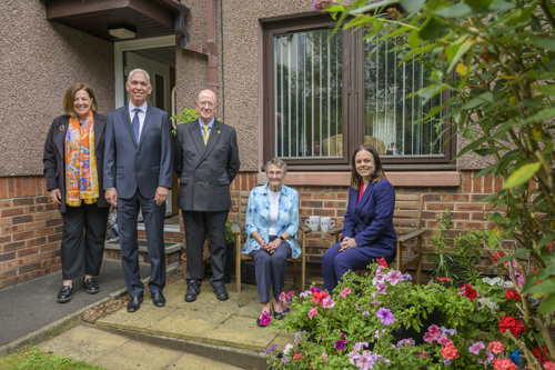 Julia Mulloy, Lawrence Fagg, Russel Griggs, Muriel and Kate Forbes outside Muriel's house smiling in her garden